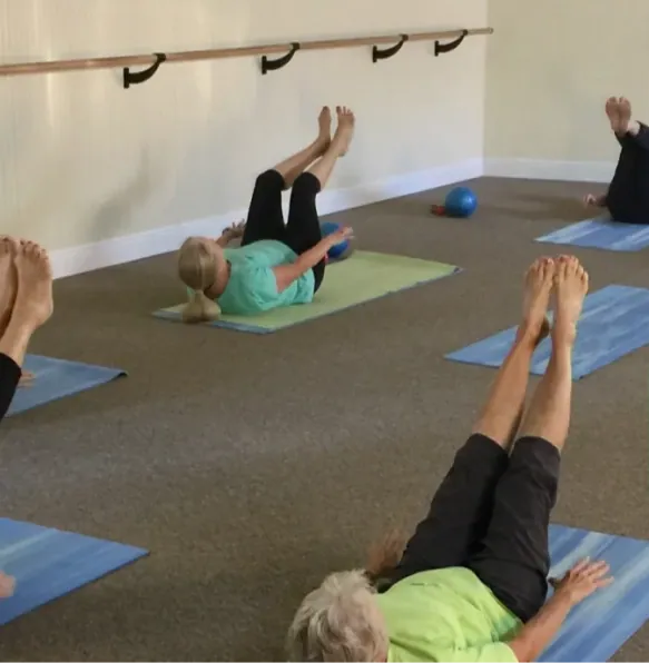 A mat class, legs lifted