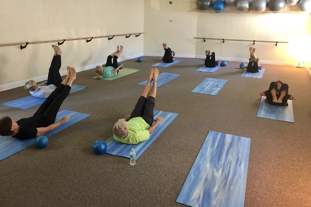 A Body Sculpt class on the mats with light weights