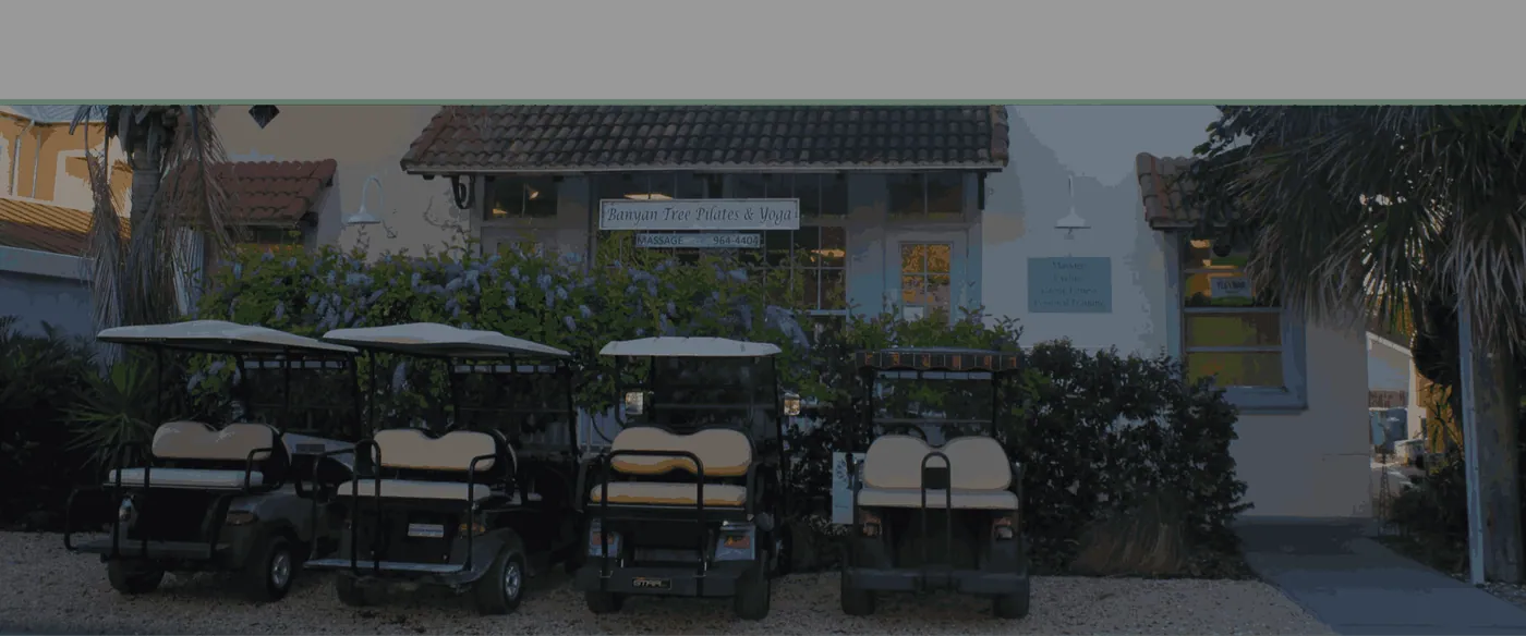 The studio's front porch on East Railroad Avenue, golf carts parked under the palms